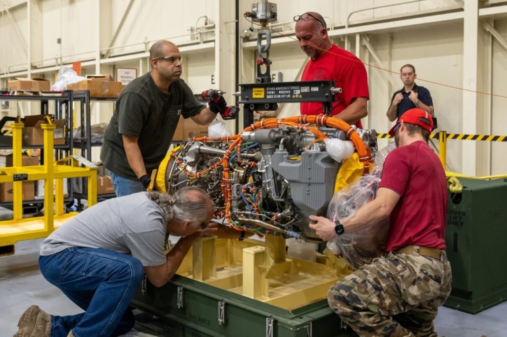 Técnicos da Sikorsky removem o motor T901 da base de transporte em West Palm Beach.